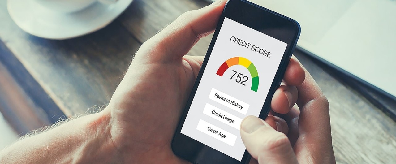 Man holding smartphone showing credit score