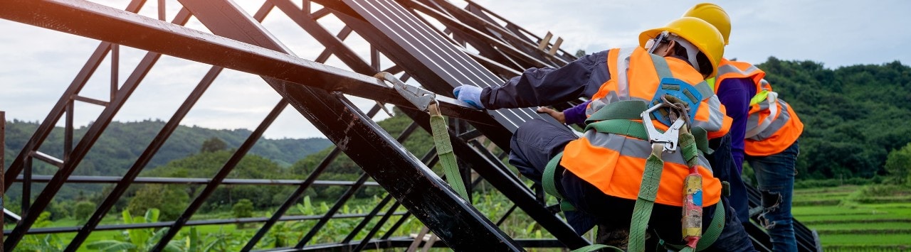 Builders constructing roof frame