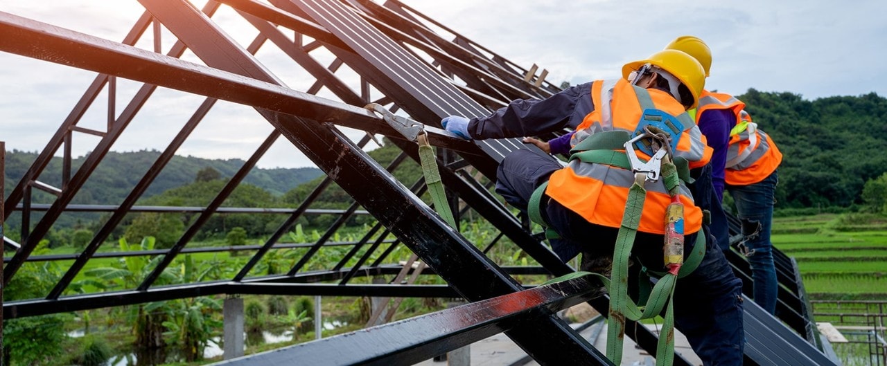 Builders constructing roof frame