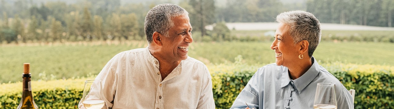 Smiling senior couple eating dinner outdoors