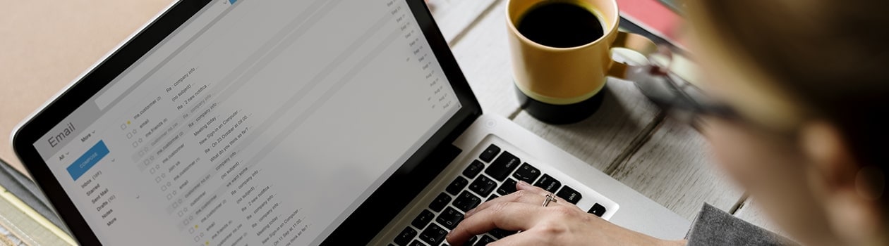 Business woman checking email on laptop