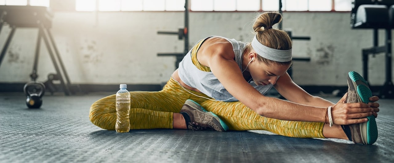 Woman stretching in gym before workout