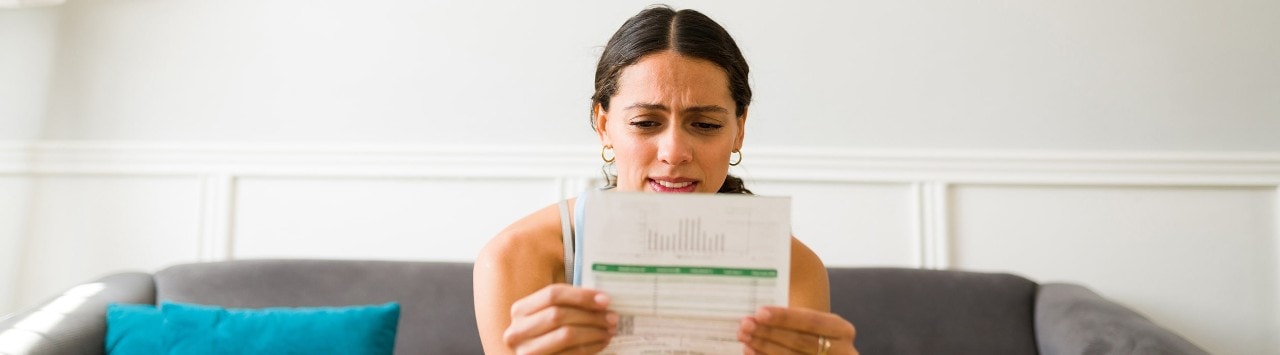 Concerned woman looking at credit card bill