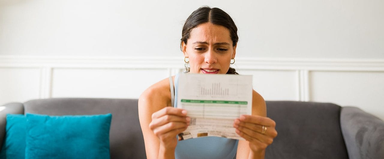 Concerned woman looking at credit card bill