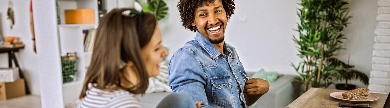 Couple sitting at table reviewing financial documents