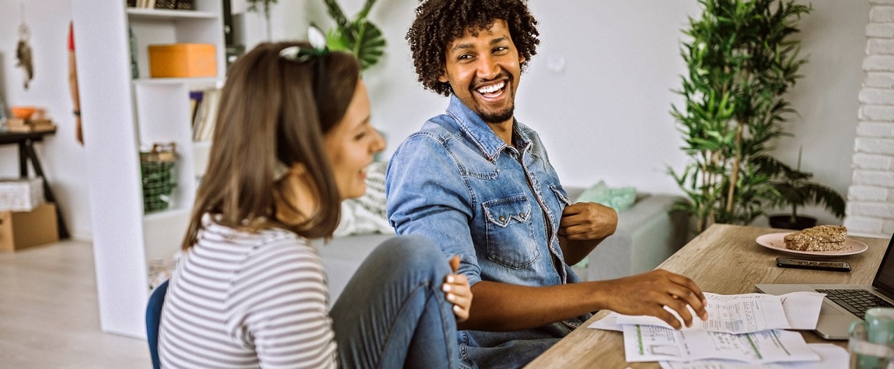 Couple sitting at table reviewing financial documents