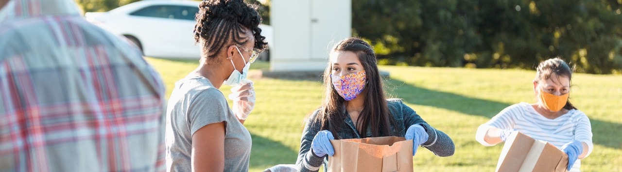 Volunteers wearing masks working at food distribution center