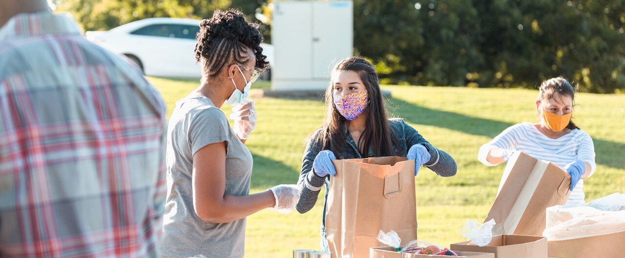 Volunteers wearing masks working at food distribution center