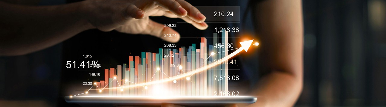 Person holding tablet showing virtual hologram of statistics, graph and chart with arrow up on dark background