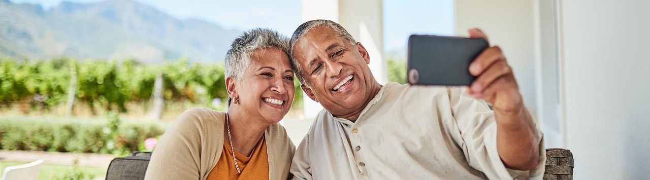 Smiling senior couple taking a selfie