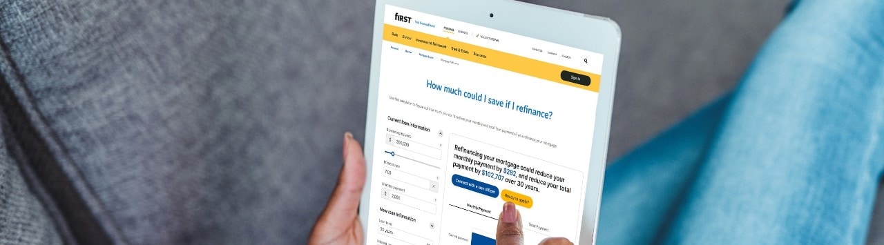 woman using tablet with digital refinancing calculator on the screen