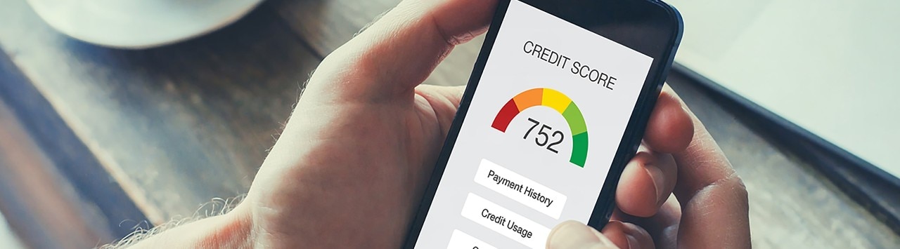 Man holding smartphone showing credit score