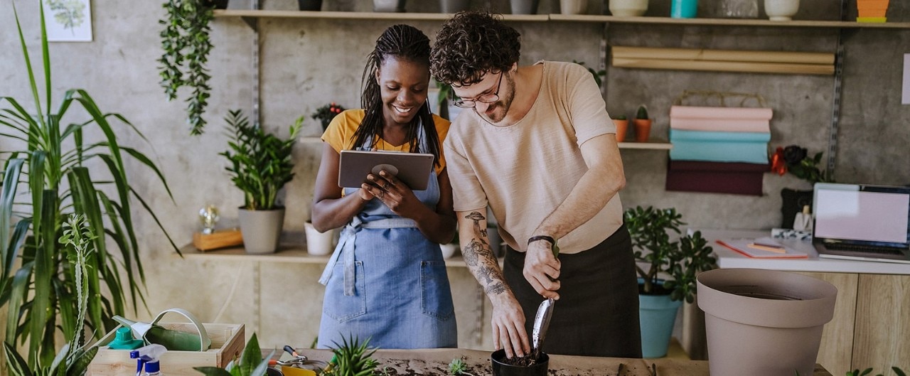 Multiracial business partners using tablet in florist shop