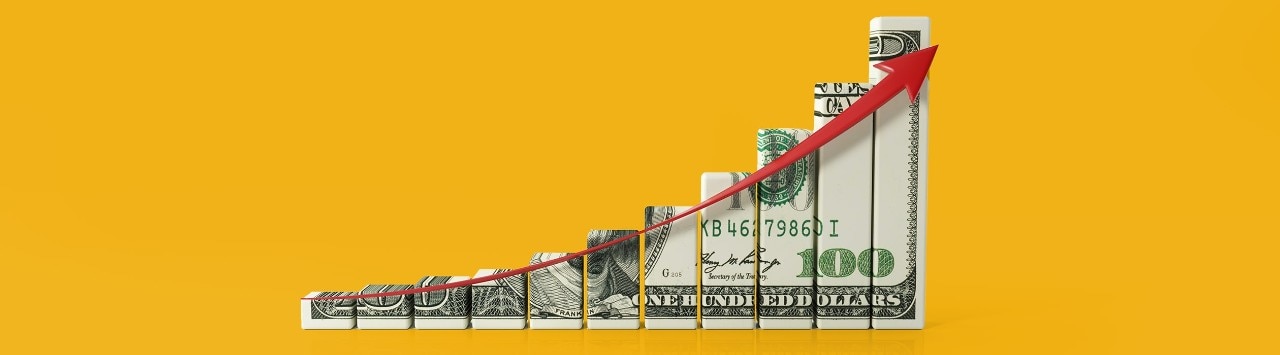 Bar graph made of $100 bill with red upward arrow illustrating growth