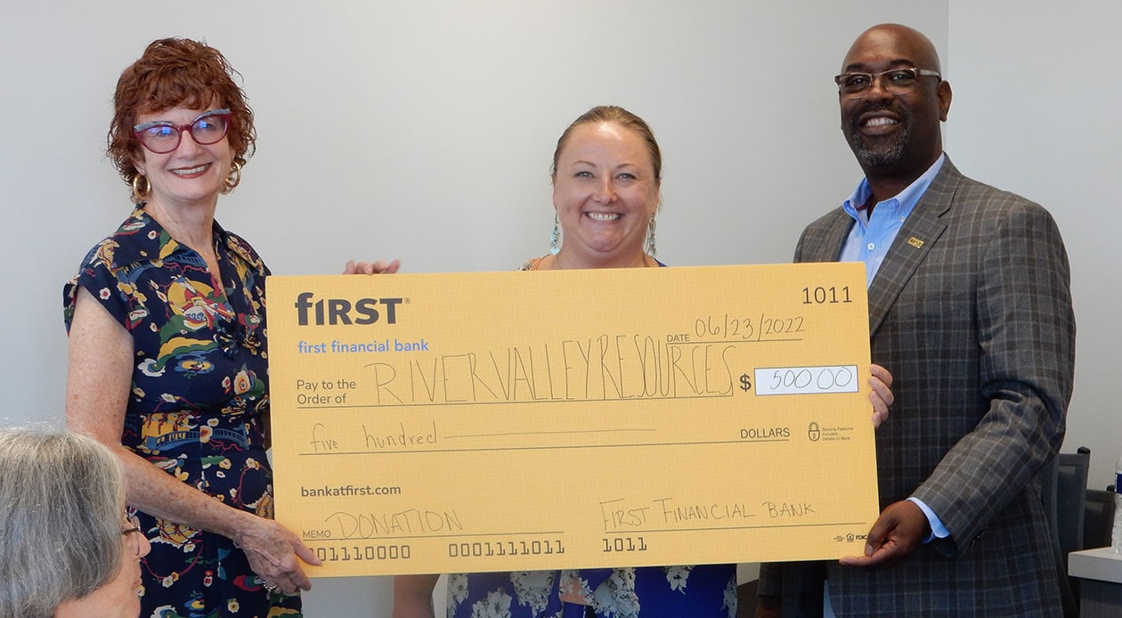 First Financial's Angela Byers and Roddell McCullough present a donation check to River Valley Resources