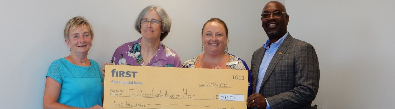 First Financial's Angela Byers and Roddell McCullough present a donation check to Jefferson County House of Hope