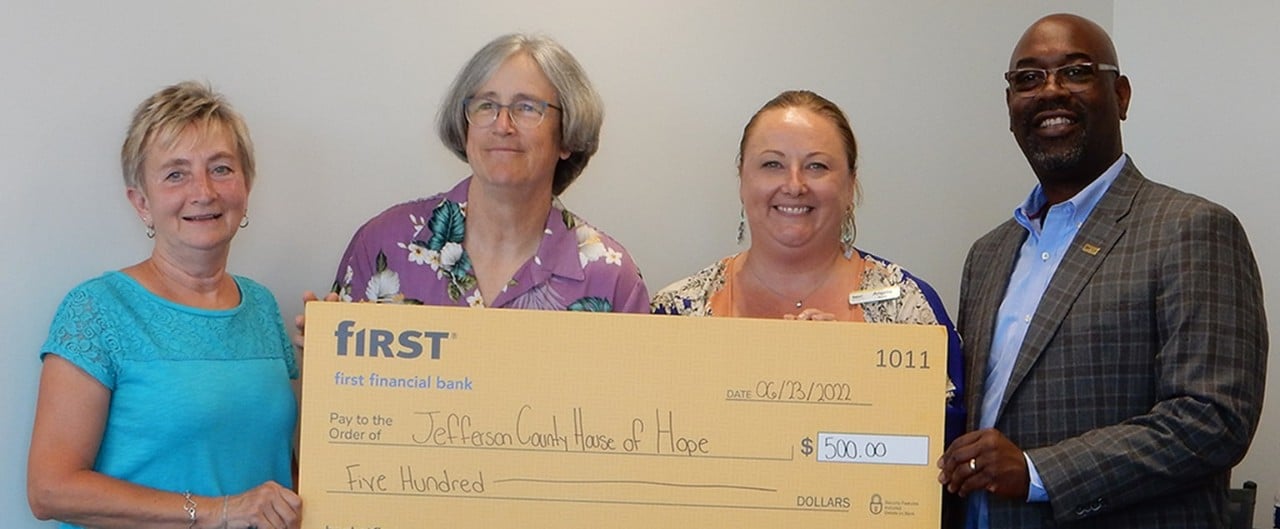 First Financial's Angela Byers and Roddell McCullough present a donation check to Jefferson County House of Hope