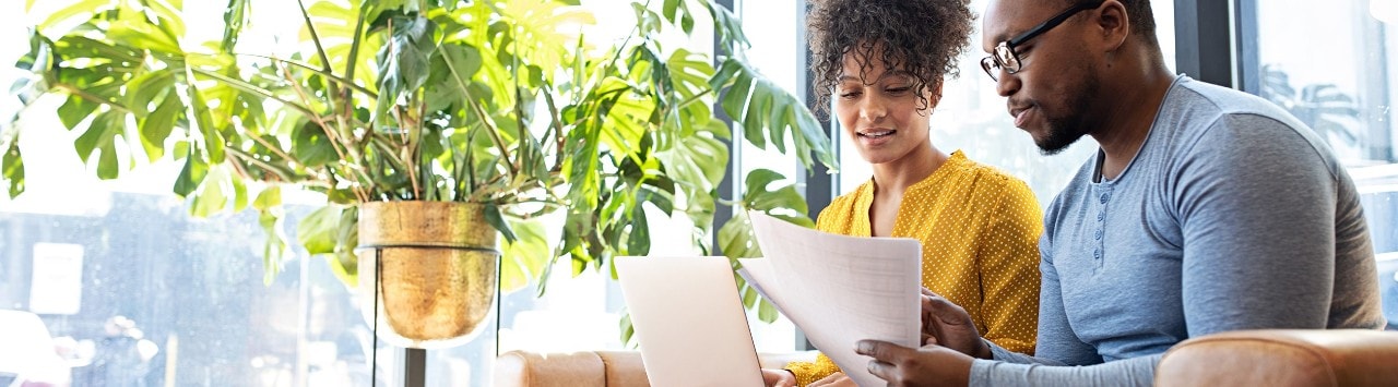 African-American couple reviewing budget at home