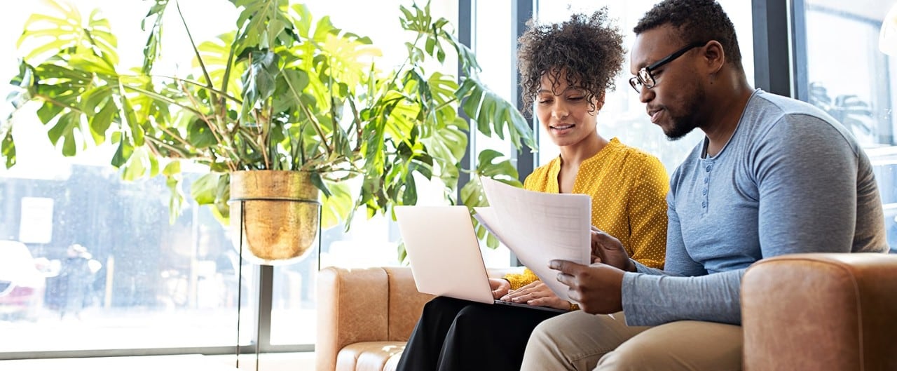 African-American couple reviewing budget at home