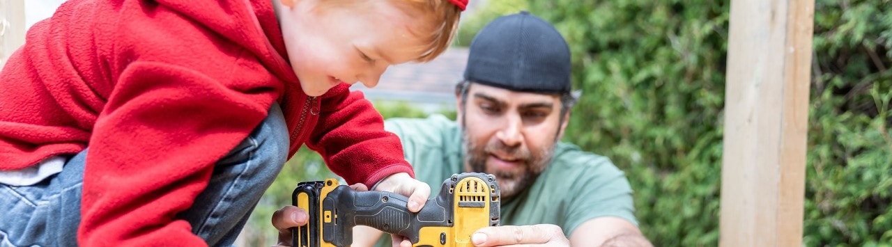 man and child operating power tools