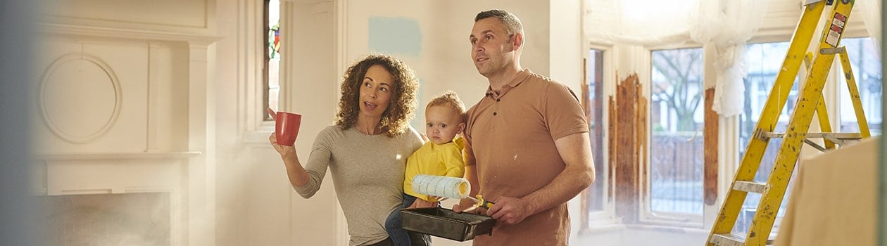 Young family looking at kitchen during home renovation