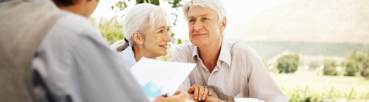 Mature couple reviewing trust plan with financial advisor