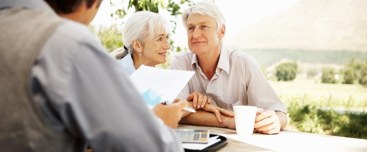 Mature couple reviewing trust plan with financial advisor