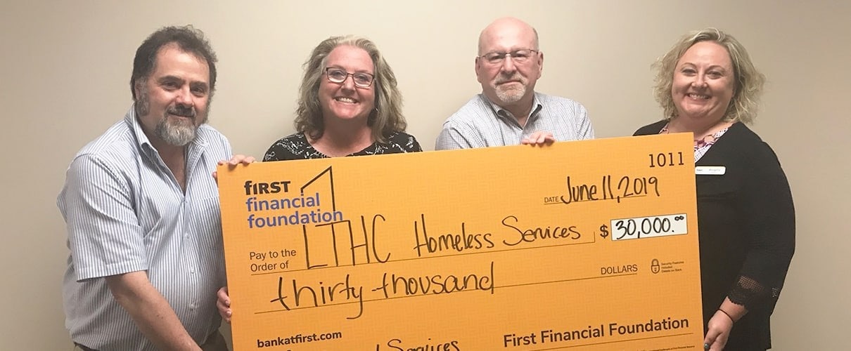 Thirty thousand dollar check for LTHC Homeless Services.