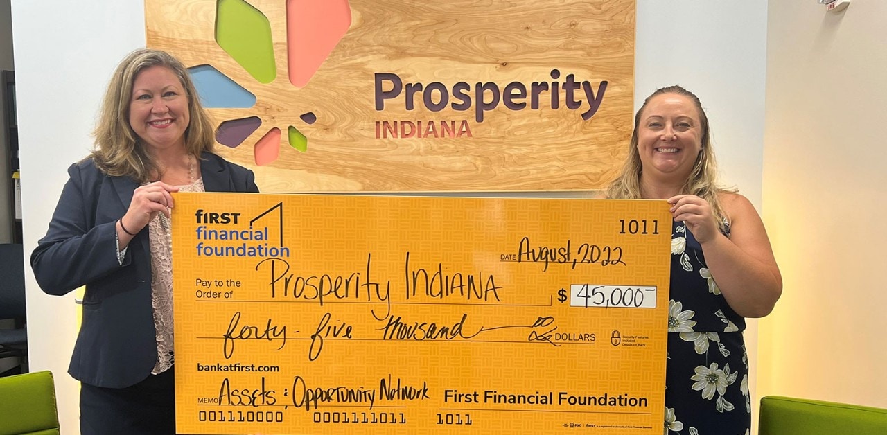 First Financial's Angela Byers presenting a $45,000 donation check to Prosperity Indiana