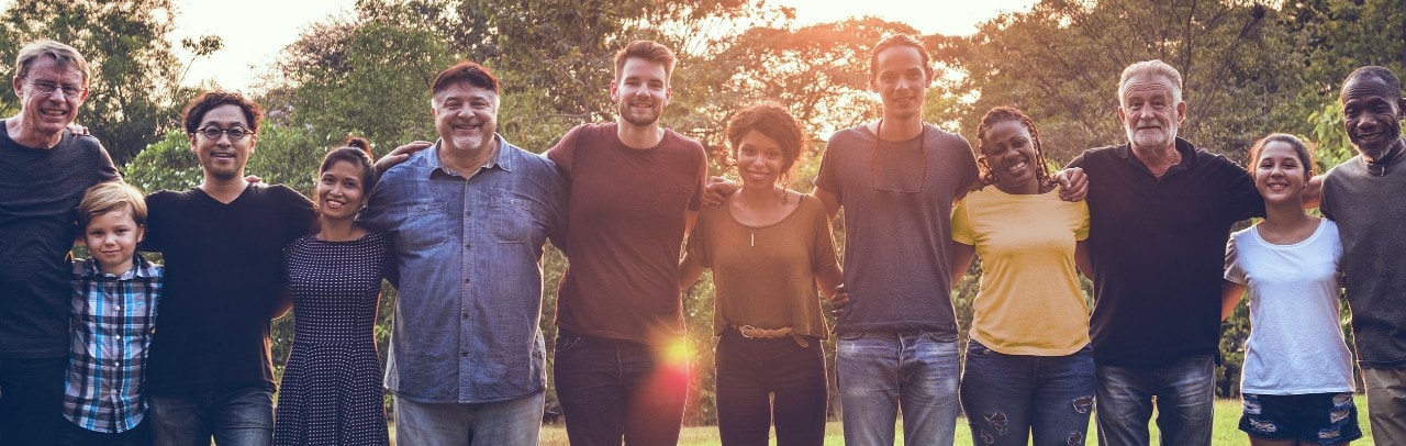 Group of people standing arm in arm 