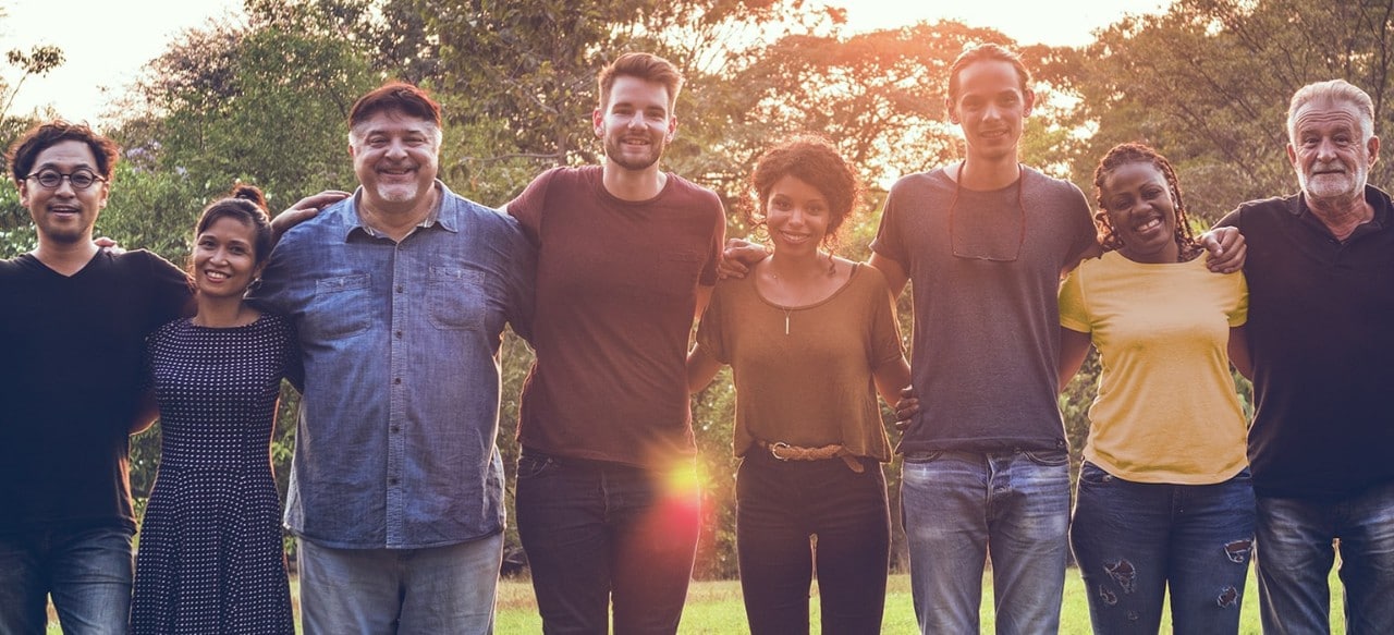 Group of people standing arm in arm 