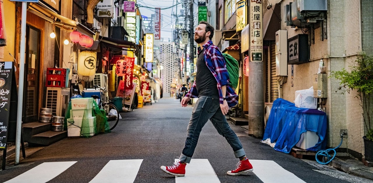 Male traveler crossing the street in a foreign city