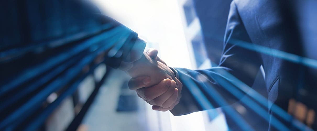 Close-up image of a handshake between businessmen