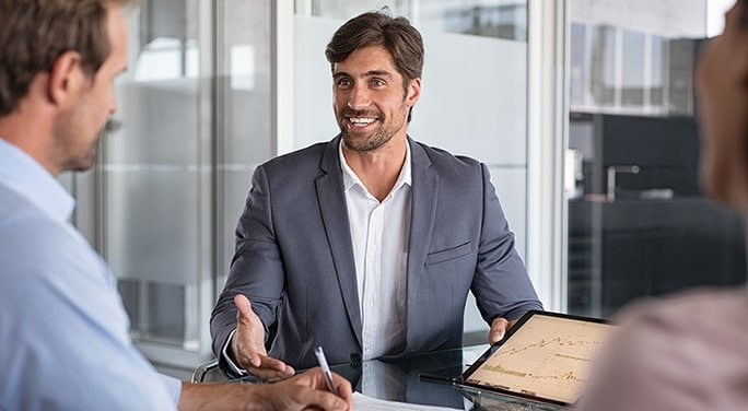 A broker speaking to clients