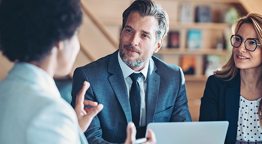 Caucasian couple meeting with African-American financial advisor