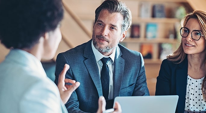 Caucasian couple meeting with African-American financial advisor