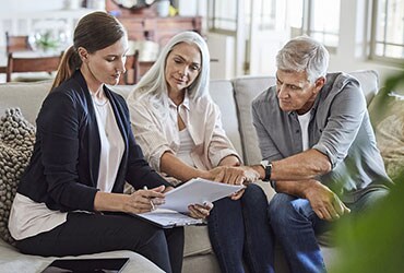 Female financial planner meeting with married couple