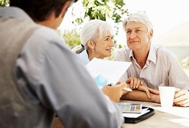 Mature couple reviewing trust plan with financial advisor