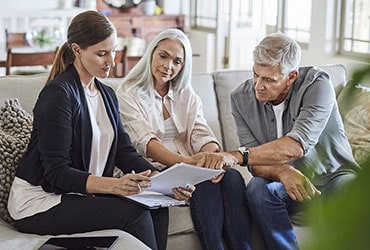 Female financial planner meeting with married couple