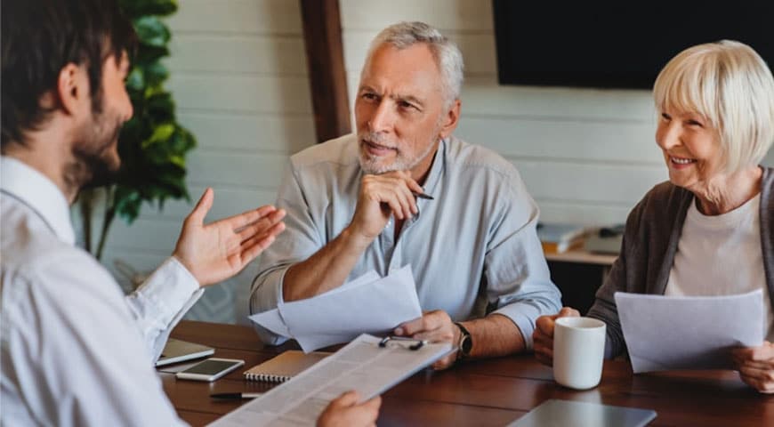 Senior couple reviewing documents with a financial advisor